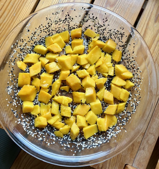 Pan coated with sesame seeds and mango on top