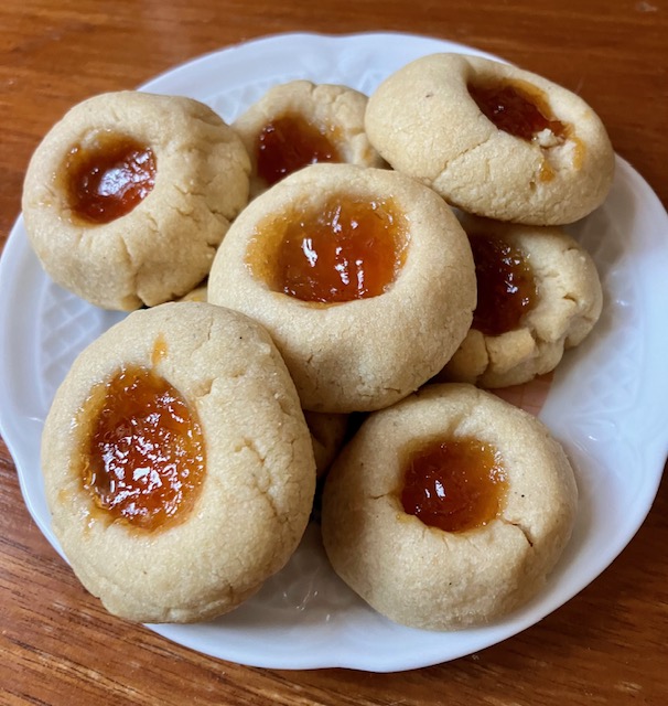 Stack of apricot tahini thumbprint cookies on a plate