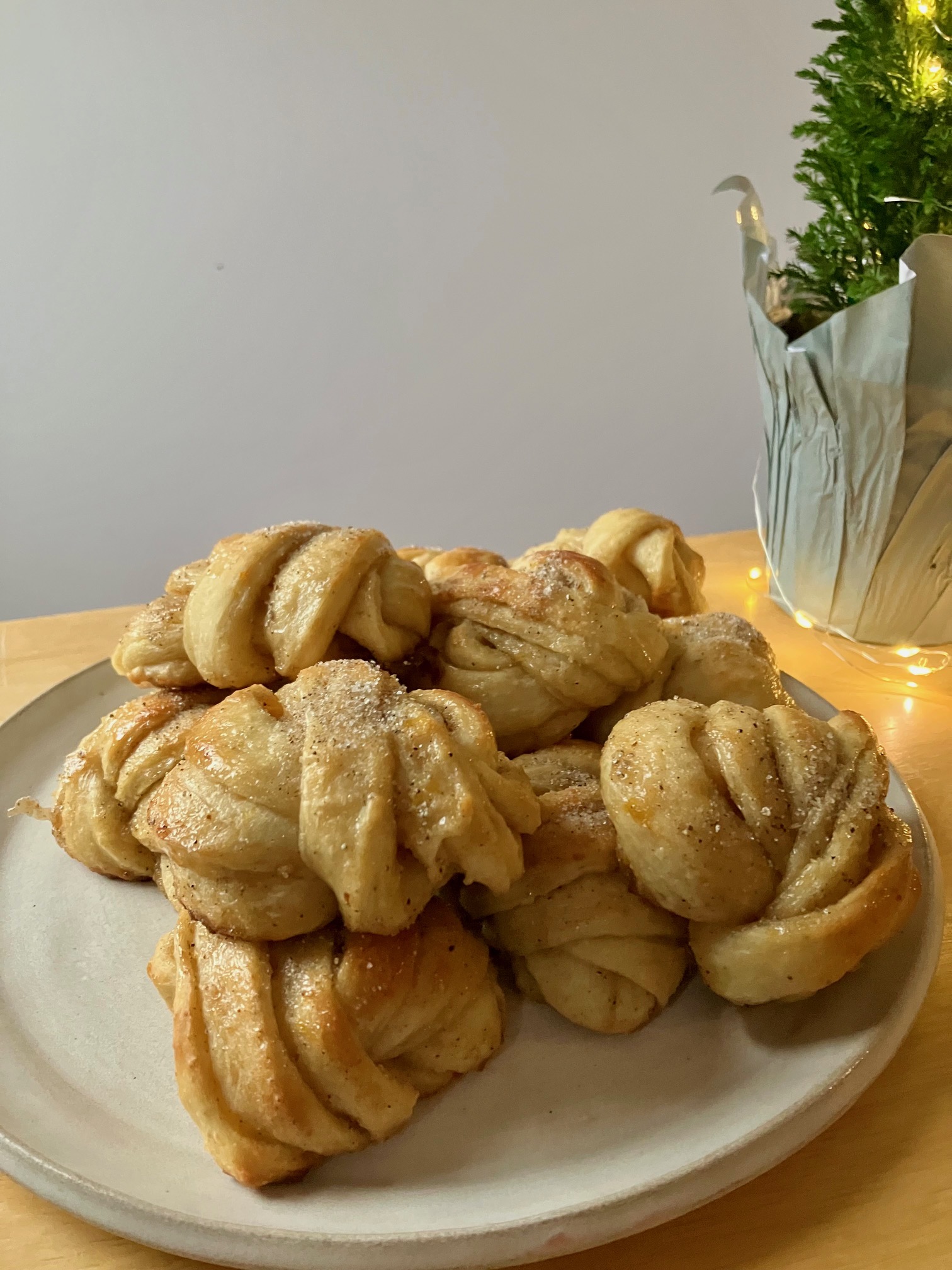 orange cardamom buns stacked on a plate