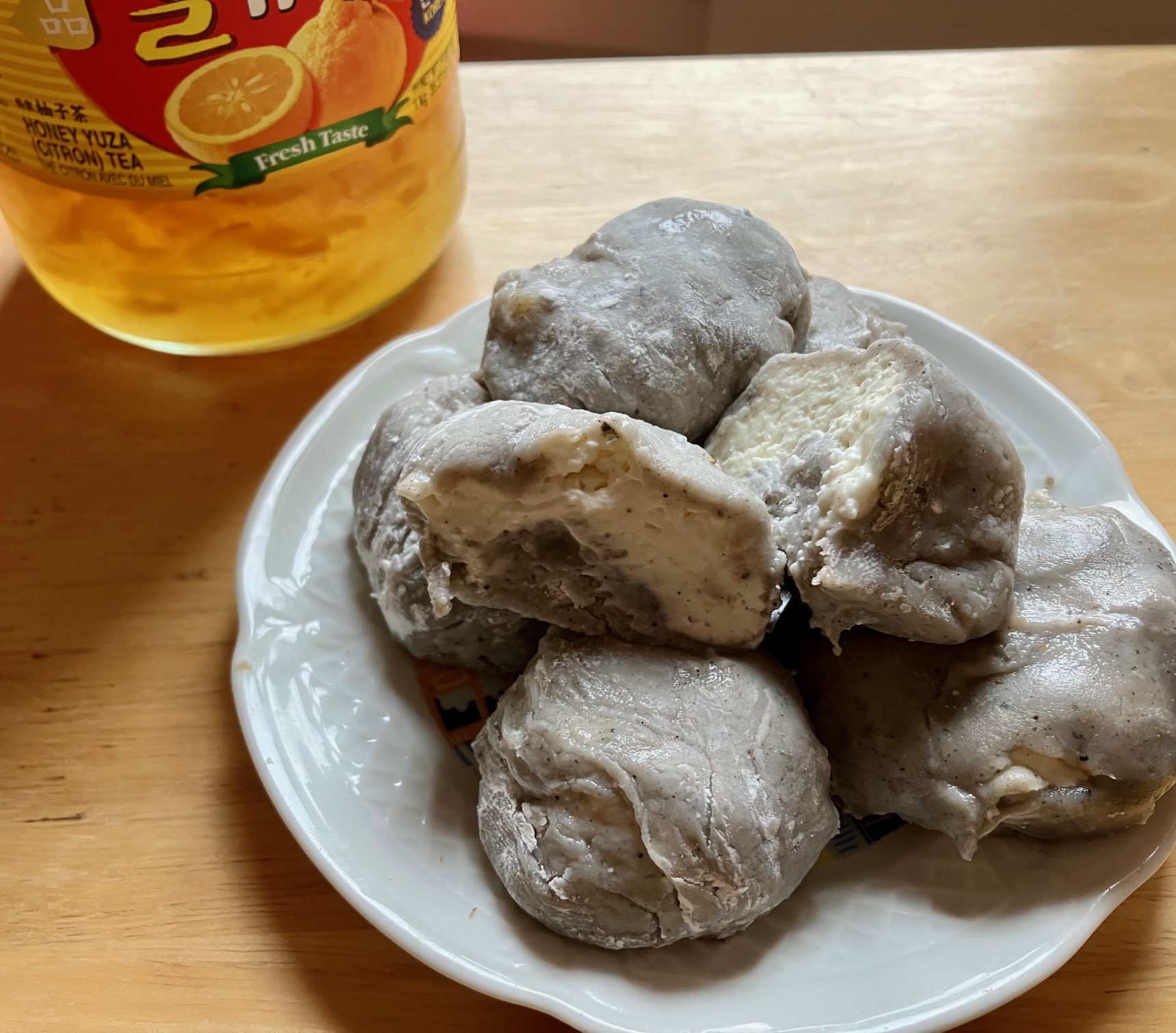 yuzu black sesame mochi stacked on a plate